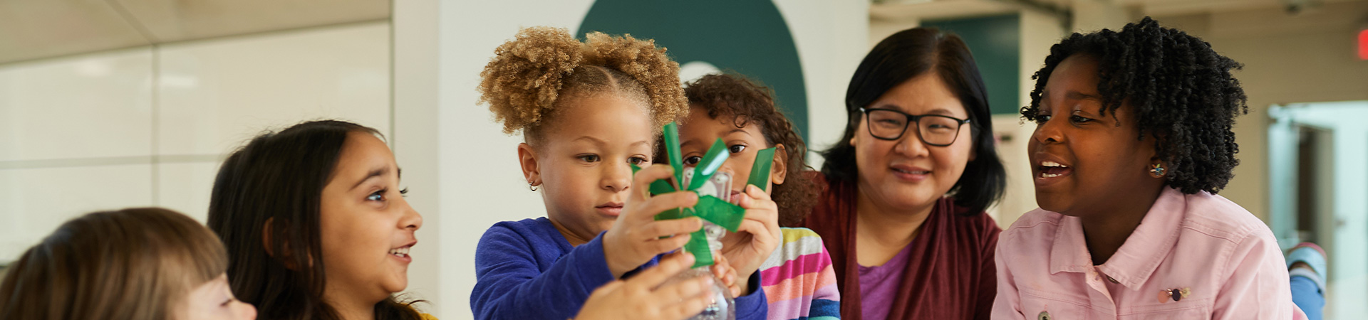  girls working together on a windmill craft 