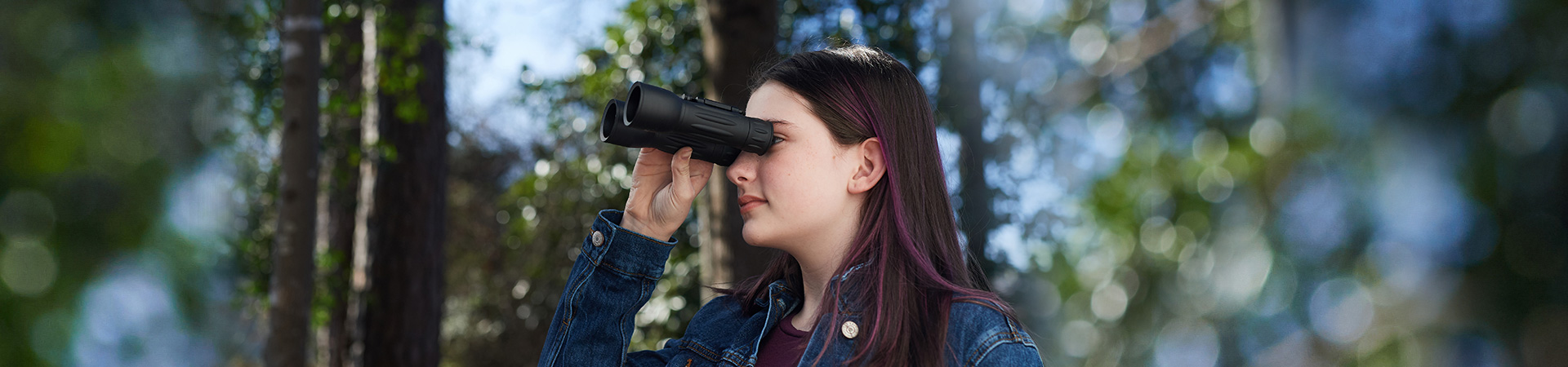  girl in the woods with binoculars 