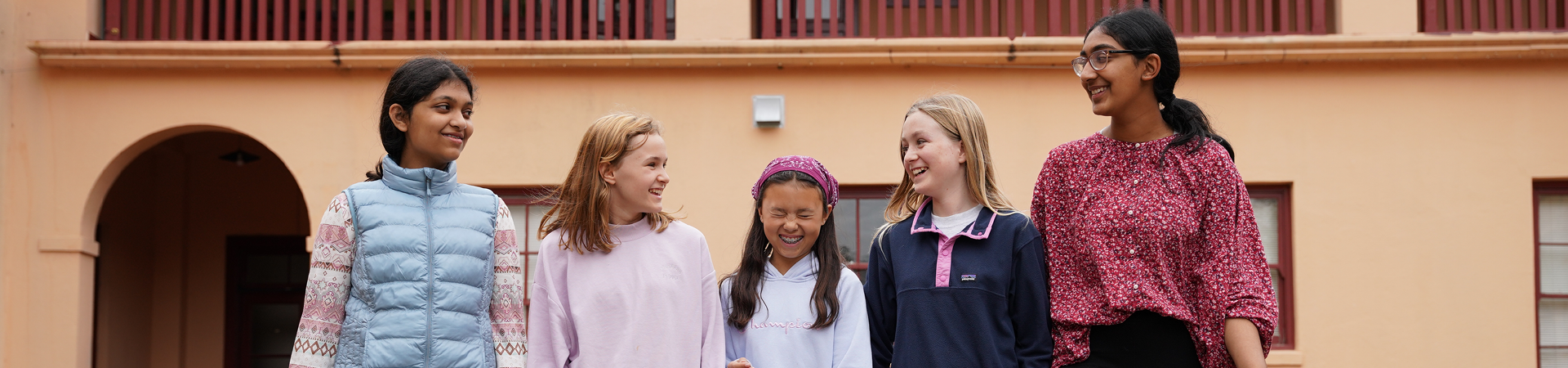  group of girl scouts smiling at each other 