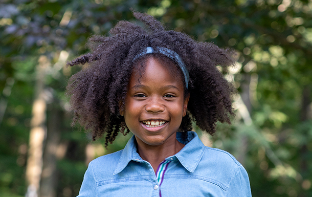 young girl outside smiling
