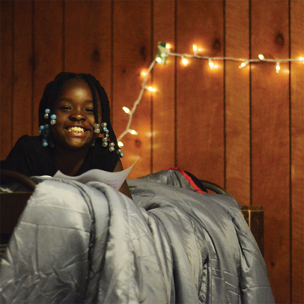 girl in cabin bunk smiling