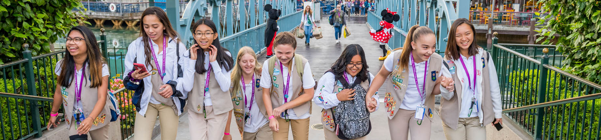  group of Girl Scouts walking through Disney Land 