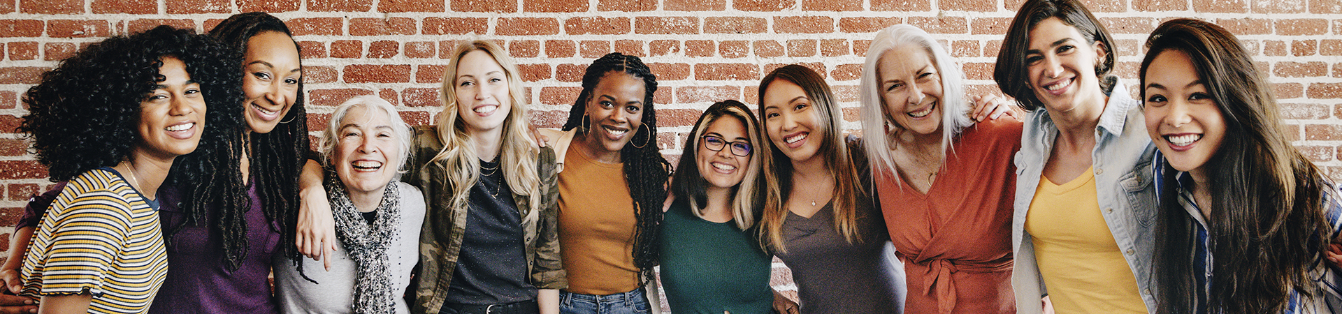  group of young girl scout alums smiling and talking to one another 